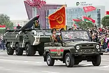 An armoured commander leading the contingent in an UAZ-469.